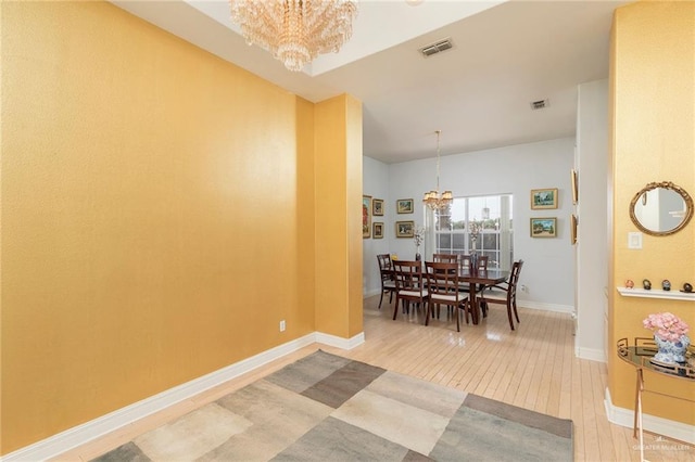 3305 W San Luis Cir, Mission, TX 78573 - dining room featuring a chandelier, light wood-style floors, and baseboards