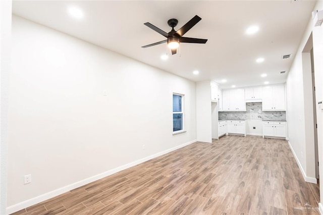 unfurnished living room with ceiling fan and light wood-type flooring