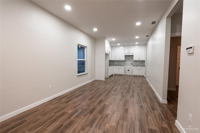 unfurnished living room with dark hardwood / wood-style floors