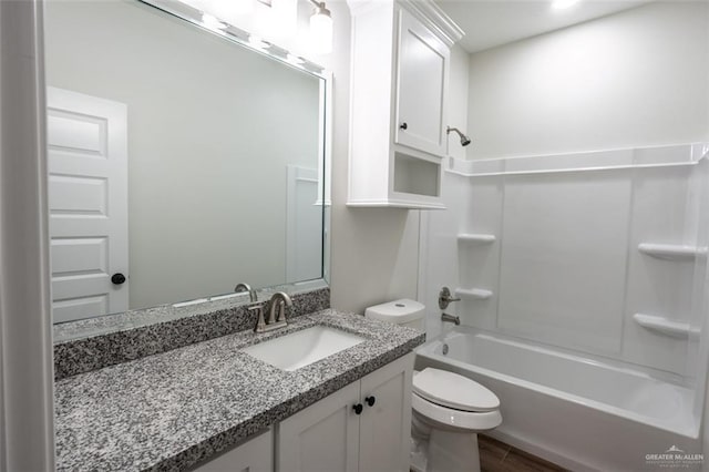 full bathroom featuring shower / washtub combination, vanity, hardwood / wood-style floors, and toilet