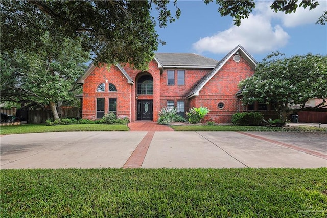 1900 E 2 Mile Line Rd, Mission, TX 78574 - view of front facade with fence, a front lawn, and brick siding