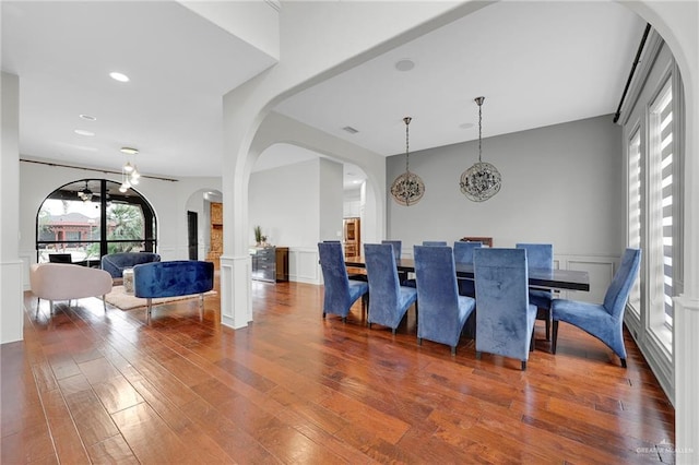 1900 E 2 Mile Line Rd, Mission, TX 78574 - dining area with wainscoting, a decorative wall, hardwood / wood-style floors, a chandelier, and arched walkways