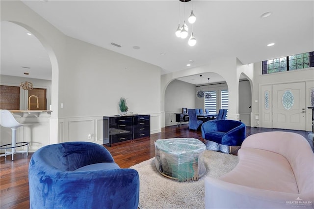1900 E 2 Mile Line Rd, Mission, TX 78574 - living area featuring arched walkways, wainscoting, wood finished floors, and a decorative wall