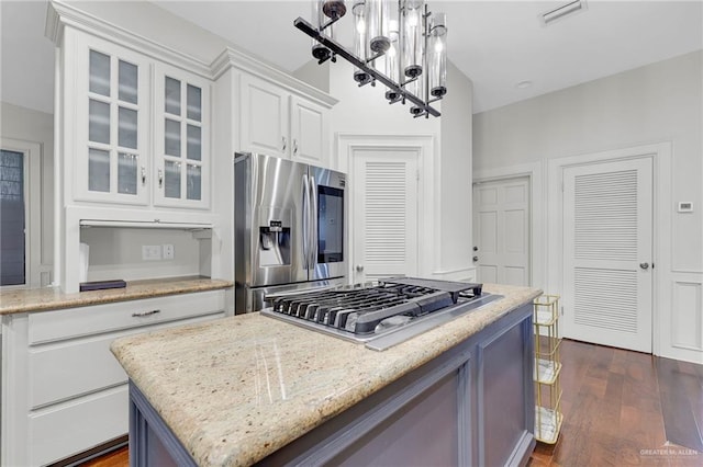 1900 E 2 Mile Line Rd, Mission, TX 78574 - kitchen featuring visible vents, appliances with stainless steel finishes, white cabinets, a notable chandelier, and glass insert cabinets
