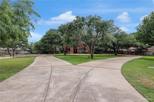 1900 E 2 Mile Line Rd, Mission, TX 78574 - surrounding community with fence, a yard, and concrete driveway