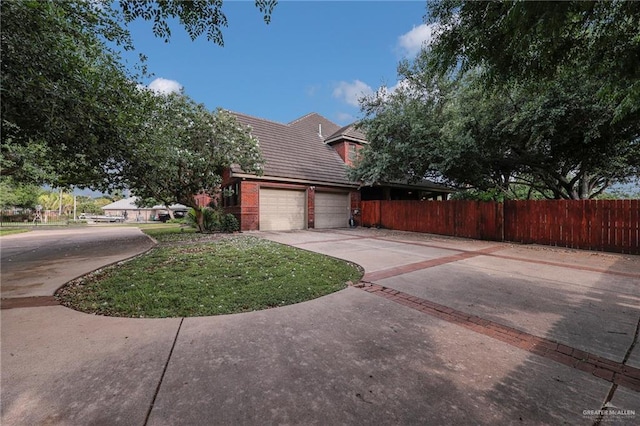 1900 E 2 Mile Line Rd, Mission, TX 78574 - view of side of home featuring a yard, fence, and driveway
