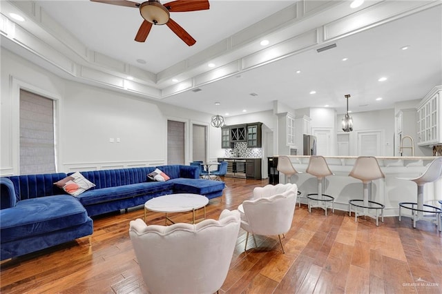 1900 E 2 Mile Line Rd, Mission, TX 78574 - living area featuring ceiling fan, visible vents, and hardwood / wood-style flooring