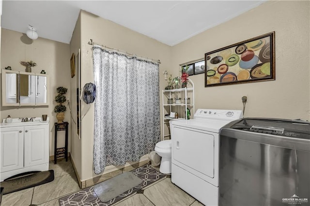 clothes washing area with washing machine and clothes dryer