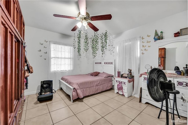 bedroom with ceiling fan and light tile patterned flooring