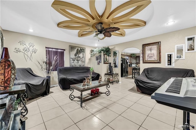 living room with ceiling fan and light tile patterned floors