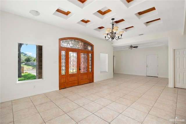 tiled foyer entrance with coffered ceiling, beamed ceiling, and a chandelier