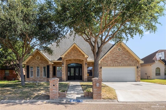 view of front of property with french doors, a garage, and an AC wall unit