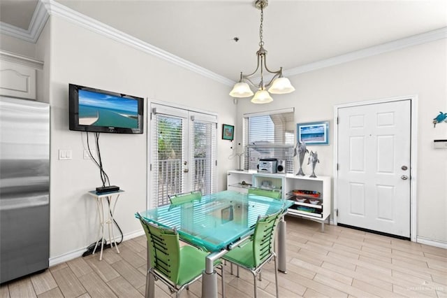 102 E Gardenia St, South Padre Island, TX 78597 - dining space featuring an inviting chandelier, baseboards, wood finish floors, and crown molding