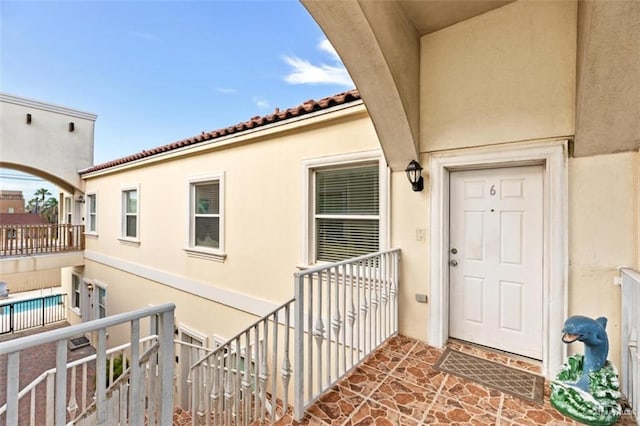 102 E Gardenia St, South Padre Island, TX 78597 - property entrance with stucco siding and a tile roof