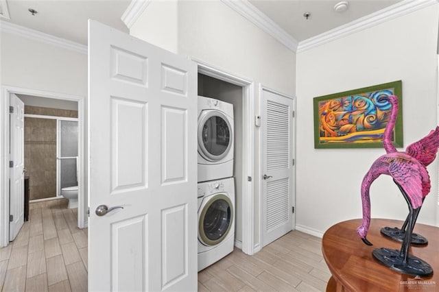 102 E Gardenia St, South Padre Island, TX 78597 - laundry room with ornamental molding, light wood finished floors, stacked washing maching and dryer, and laundry area