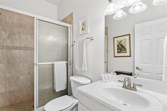 102 E Gardenia St, South Padre Island, TX 78597 - bathroom with a shower stall, toilet, vanity, and a chandelier