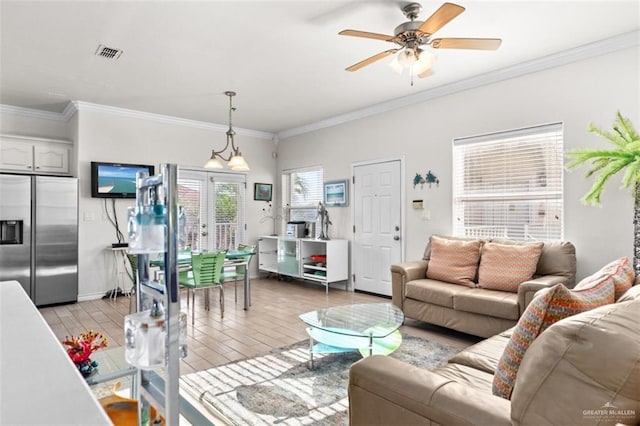 102 E Gardenia St, South Padre Island, TX 78597 - living room featuring light wood finished floors, a ceiling fan, visible vents, and crown molding
