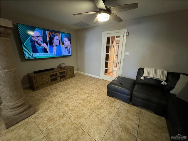 home theater featuring ceiling fan, light tile patterned floors, and ornate columns