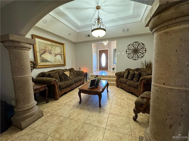 tiled living room with a raised ceiling and ornate columns