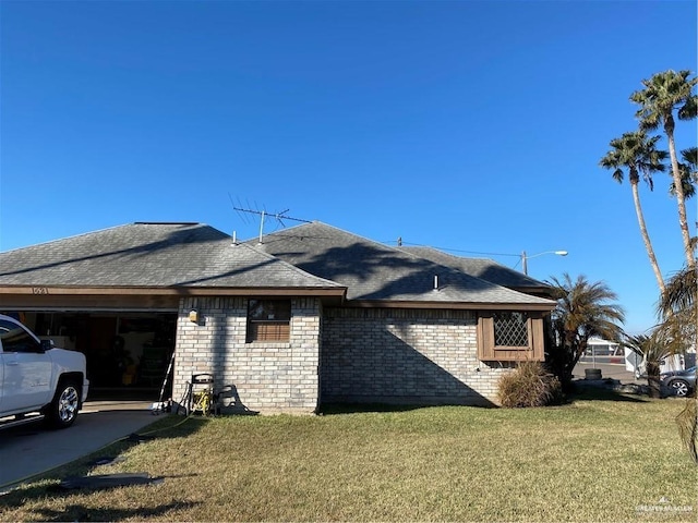 view of home's exterior featuring a garage and a yard