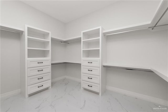 spacious closet with marble finish floor
