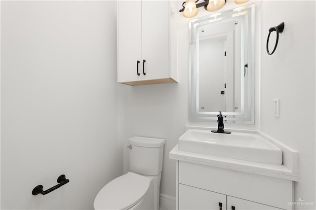 half bathroom featuring toilet and vanity