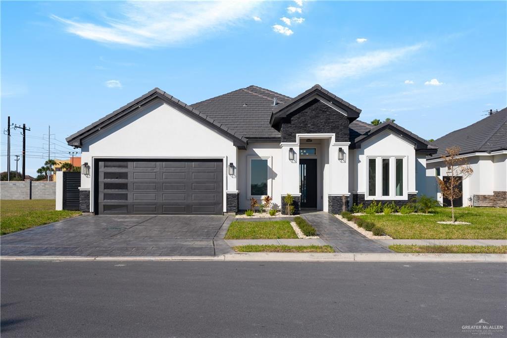 3101 W Brentwood St, Edinburg, TX 78539 - ranch-style home with stone siding, stucco siding, and a garage