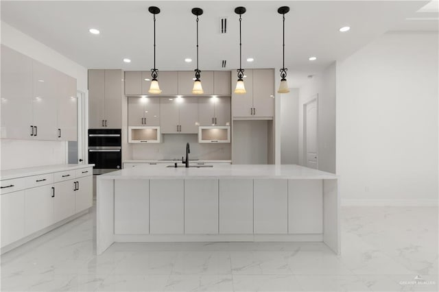 kitchen featuring modern cabinets, dobule oven black, marble finish floor, and a sink