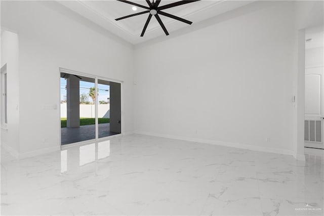 spare room featuring baseboards, a ceiling fan, and marble finish floor