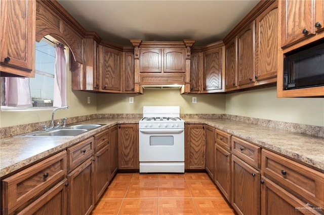 kitchen featuring white gas range and sink