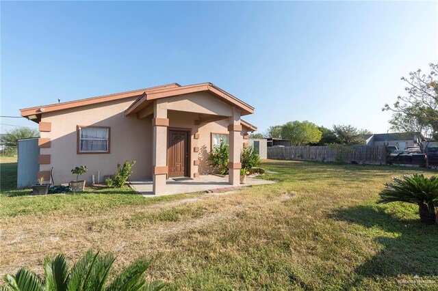 rear view of property featuring a lawn