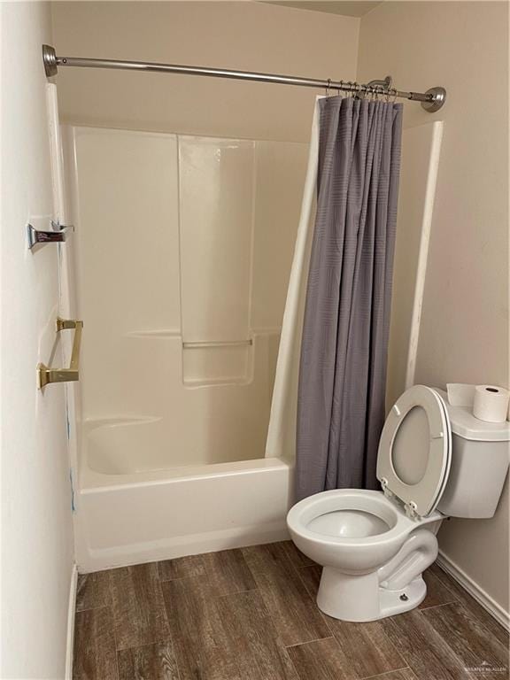 bathroom featuring toilet, shower / tub combo, and hardwood / wood-style flooring