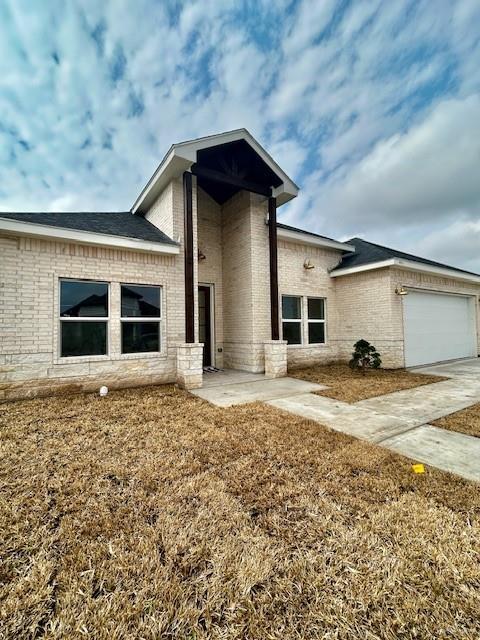 rear view of property featuring a garage