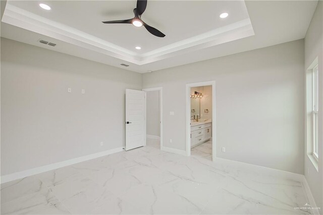 unfurnished bedroom featuring baseboards, visible vents, a raised ceiling, marble finish floor, and recessed lighting