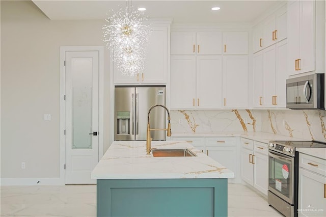 kitchen featuring appliances with stainless steel finishes, white cabinetry, a sink, and decorative backsplash