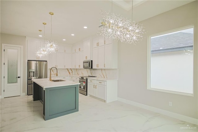 kitchen with a notable chandelier, a sink, white cabinetry, marble finish floor, and appliances with stainless steel finishes