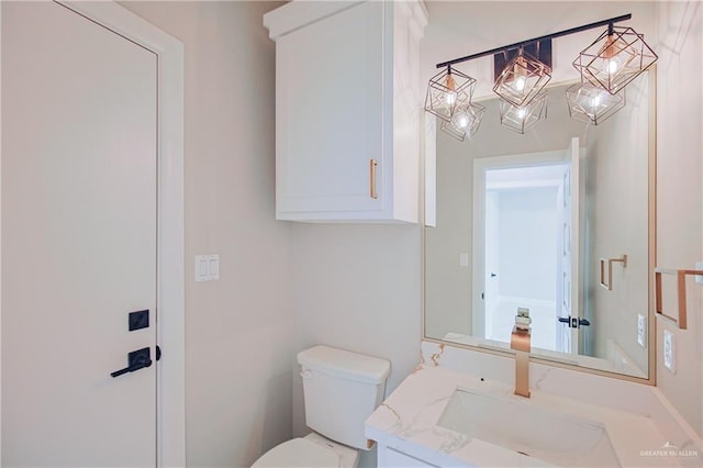 bathroom with toilet and vanity