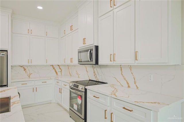 kitchen with light stone countertops, marble finish floor, stainless steel appliances, white cabinetry, and backsplash