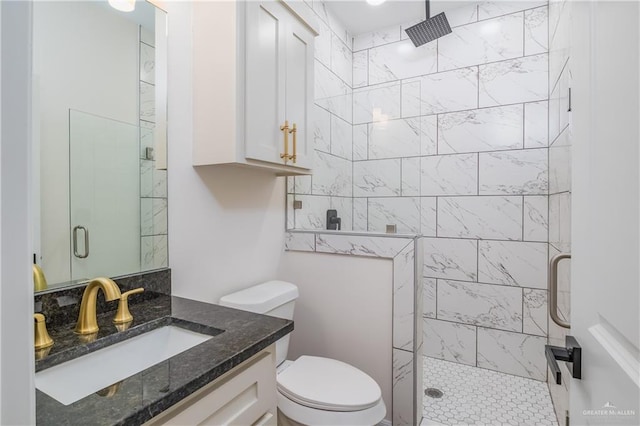 full bath with vanity, toilet, and a shower stall