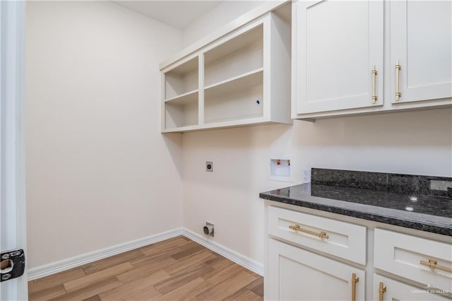 laundry room with washer hookup, hookup for an electric dryer, cabinet space, baseboards, and light wood finished floors