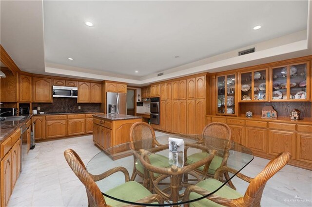 dining room with a tray ceiling and sink