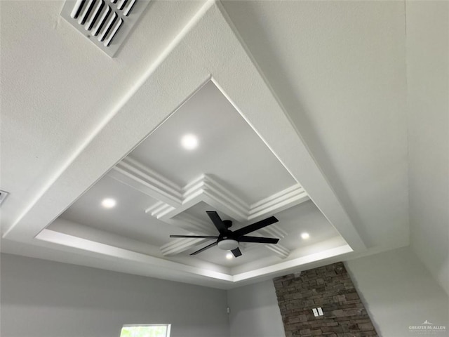 details featuring a tray ceiling, ceiling fan, and crown molding