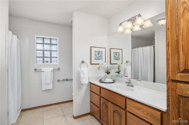 bathroom featuring tile patterned flooring, vanity, and baseboards