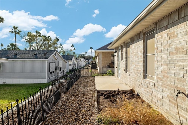 view of yard with a patio area, fence, and a residential view