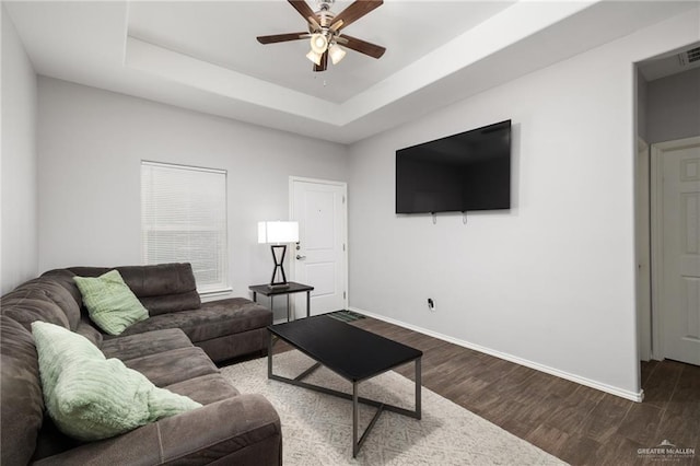 909 N Maryland St, Alton, TX 78573 - living room with a ceiling fan, baseboards, wood finished floors, and a raised ceiling