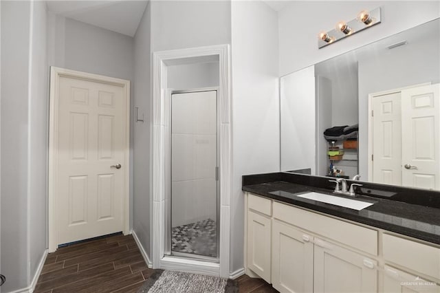 909 N Maryland St, Alton, TX 78573 - full bathroom featuring wood finished floors, a shower stall, baseboards, and vanity