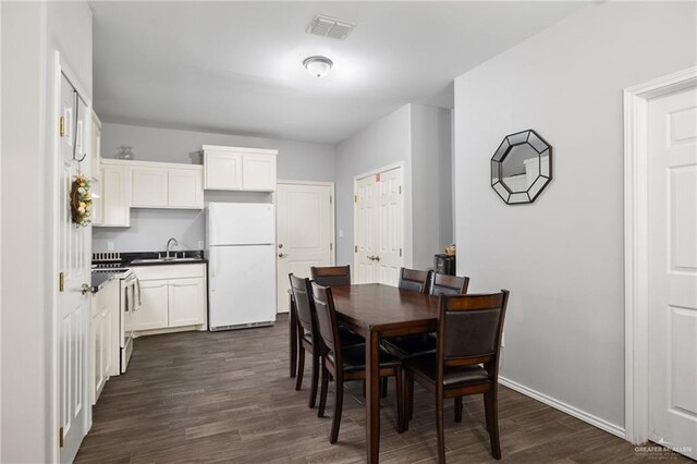 909 N Maryland St, Alton, TX 78573 - dining area with dark wood-type flooring and baseboards