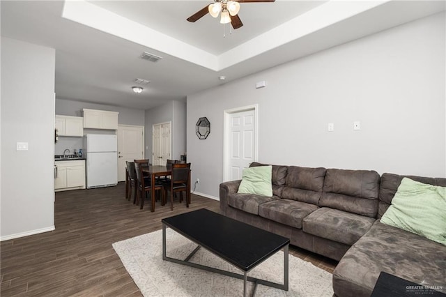 909 N Maryland St, Alton, TX 78573 - living area featuring a ceiling fan, baseboards, and dark wood finished floors