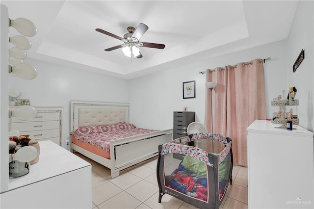 303 S Ridge Ln, San Juan, TX 78589 - bedroom featuring a tray ceiling, light tile patterned floors, and ceiling fan