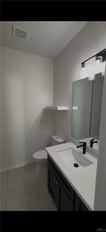 bathroom with tile patterned floors, visible vents, toilet, baseboards, and vanity